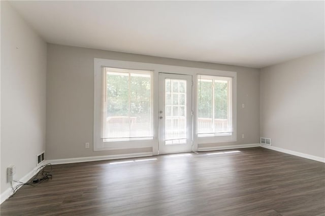 2311 Cherry Blossom Dr SW, Atlanta, GA 30331 - empty room featuring healthy amount of natural light, dark wood-style floors, and baseboards