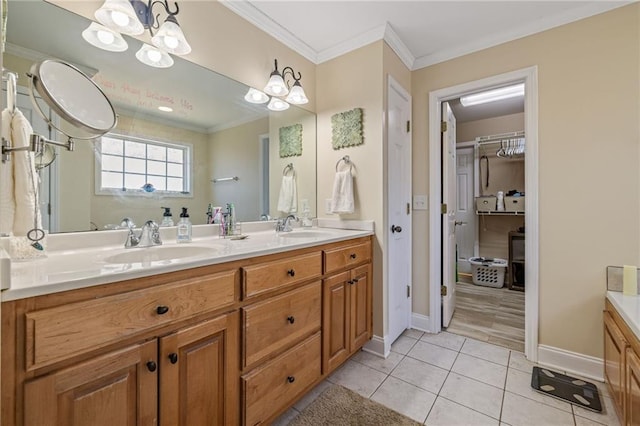 bathroom with crown molding, an inviting chandelier, tile patterned floors, a sink, and double vanity