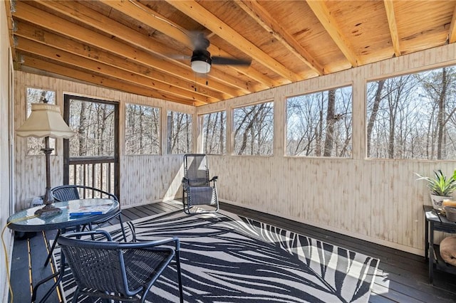 sunroom / solarium featuring beamed ceiling, outdoor dining space, and a ceiling fan