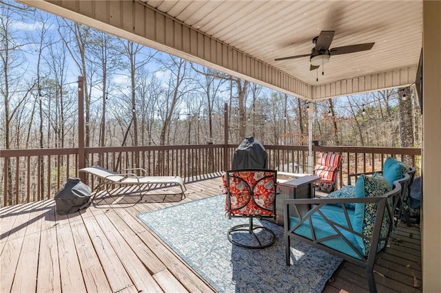 wooden deck featuring a ceiling fan