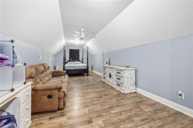 bedroom featuring visible vents, baseboards, wood finished floors, a ceiling fan, and vaulted ceiling