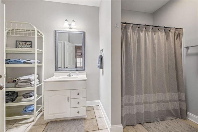 full bath with tile patterned floors, vanity, curtained shower, and baseboards