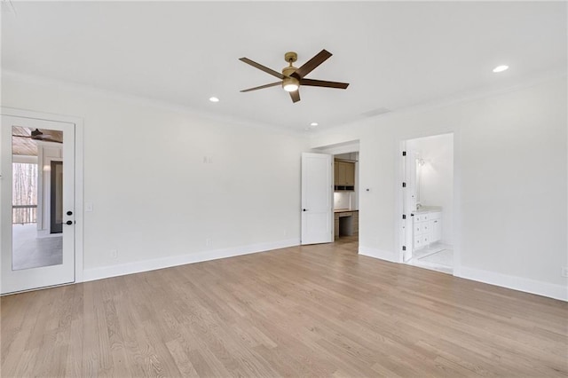 spare room with ceiling fan, crown molding, and light hardwood / wood-style floors