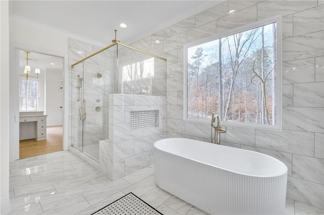 bathroom with tile walls and shower with separate bathtub