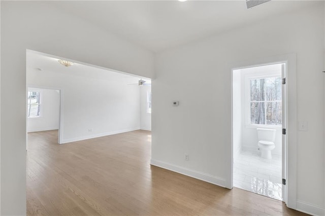 empty room with light hardwood / wood-style flooring and ceiling fan