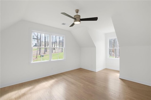 additional living space featuring vaulted ceiling, ceiling fan, and light hardwood / wood-style floors