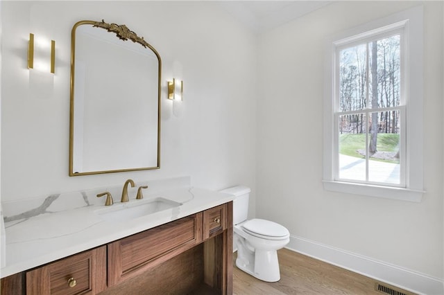 bathroom featuring vanity, hardwood / wood-style floors, and toilet