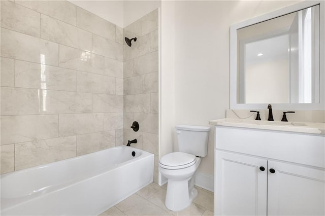 full bathroom featuring vanity, tile patterned floors, toilet, and tiled shower / bath