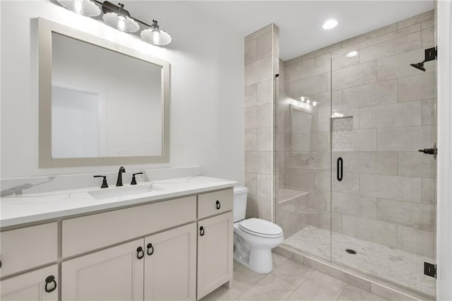 bathroom with vanity, toilet, and an enclosed shower