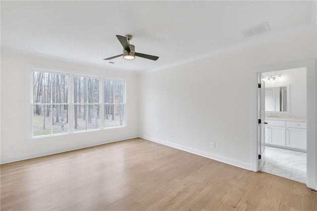 empty room with light hardwood / wood-style floors and ceiling fan