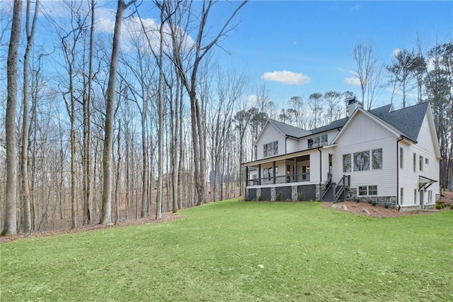 exterior space featuring covered porch and a lawn