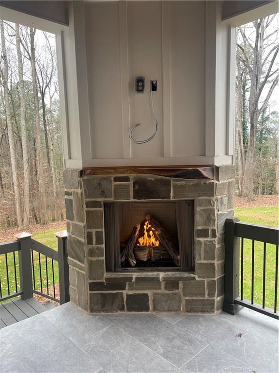 details with an outdoor stone fireplace