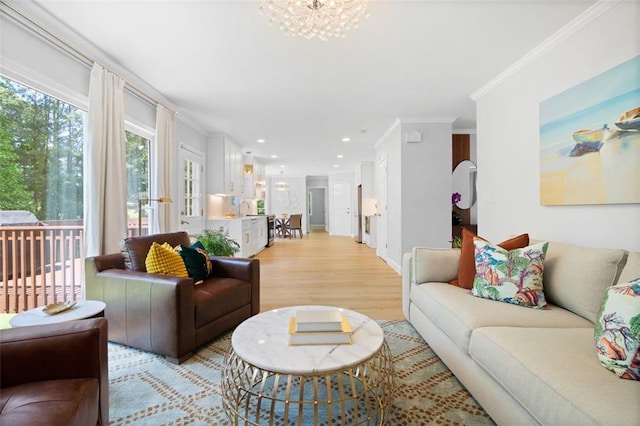 1661 Duxbury Ln NW, Kennesaw, GA 30152 - living room featuring crown molding, light wood finished floors, a chandelier, recessed lighting, and baseboards