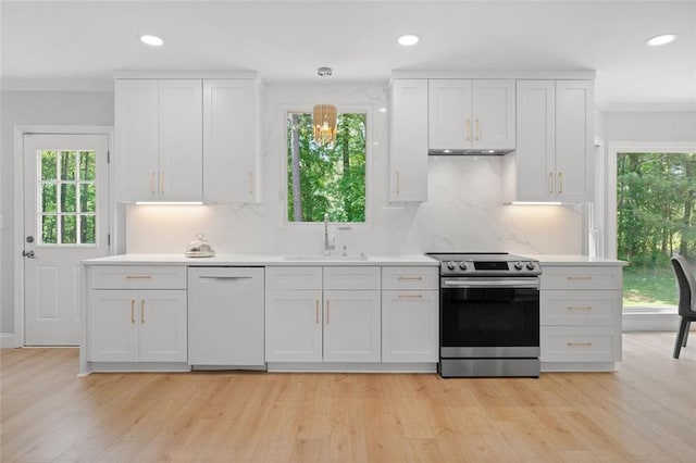 1661 Duxbury Ln NW, Kennesaw, GA 30152 - kitchen with electric range, white dishwasher, a sink, ornamental molding, and healthy amount of natural light