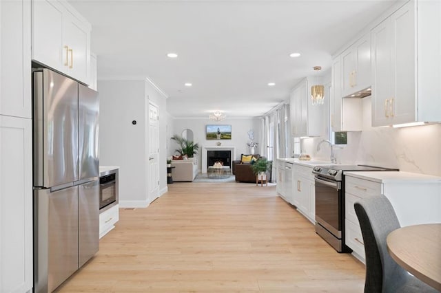 1661 Duxbury Ln NW, Kennesaw, GA 30152 - kitchen featuring appliances with stainless steel finishes, white cabinetry, light countertops, a sink, and recessed lighting