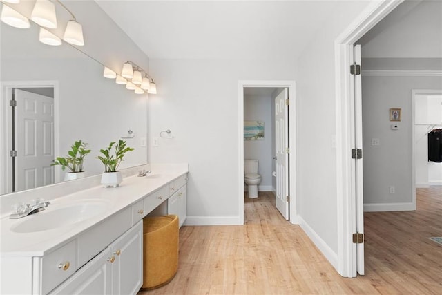 1661 Duxbury Ln NW, Kennesaw, GA 30152 - bathroom with wood finished floors, baseboards, toilet, and double vanity