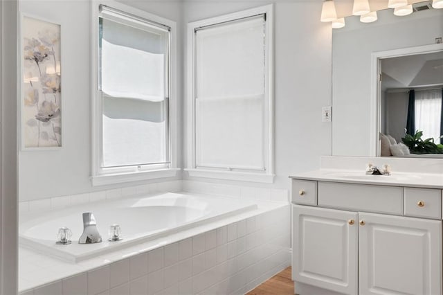 1661 Duxbury Ln NW, Kennesaw, GA 30152 - full bathroom with vanity, a garden tub, wood finished floors, and connected bathroom