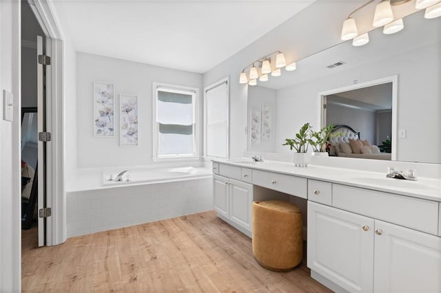 1661 Duxbury Ln NW, Kennesaw, GA 30152 - bathroom with ensuite bath, wood finished floors, double vanity, and a bath