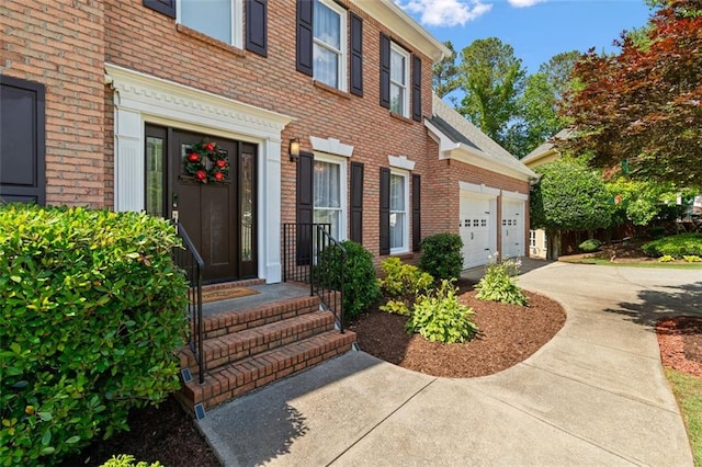 1661 Duxbury Ln NW, Kennesaw, GA 30152 - doorway to property featuring brick siding, concrete driveway, and a garage