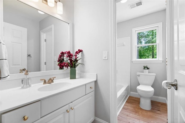 1661 Duxbury Ln NW, Kennesaw, GA 30152 - full bath featuring vanity, wood finished floors, baseboards, and toilet