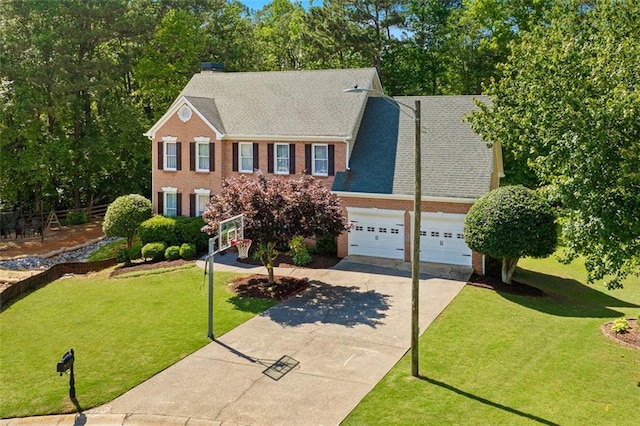 1661 Duxbury Ln NW, Kennesaw, GA 30152 - colonial home with driveway, an attached garage, brick siding, a chimney, and a front lawn