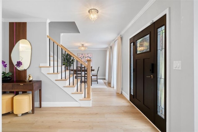 1661 Duxbury Ln NW, Kennesaw, GA 30152 - foyer entrance featuring a chandelier, crown molding, stairway, wood finished floors, and healthy amount of natural light