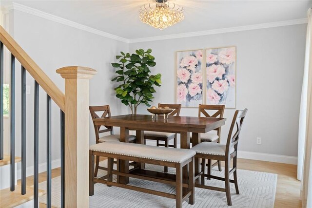 1661 Duxbury Ln NW, Kennesaw, GA 30152 - dining space featuring baseboards, ornamental molding, a chandelier, and light wood finished floors