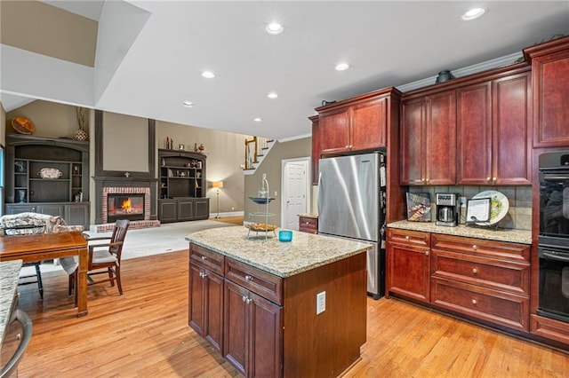 4842 Registry Dr NW, Kennesaw, GA 30152 - kitchen with freestanding refrigerator, dark brown cabinets, a kitchen island, light wood-type flooring, and tasteful backsplash