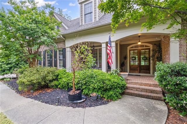 4842 Registry Dr NW, Kennesaw, GA 30152 - view of exterior entry featuring french doors, roof with shingles, brick siding, and a porch