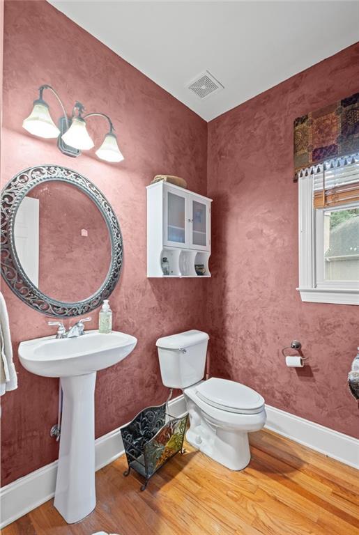 4842 Registry Dr NW, Kennesaw, GA 30152 - half bathroom with wood finished floors, toilet, and baseboards