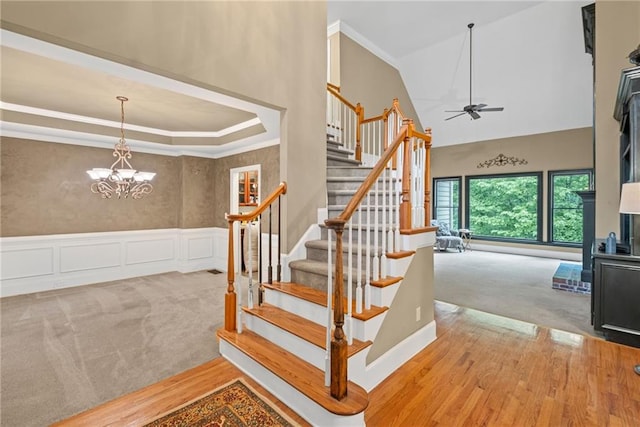 4842 Registry Dr NW, Kennesaw, GA 30152 - staircase with carpet floors, a high ceiling, ceiling fan, crown molding, and wood finished floors