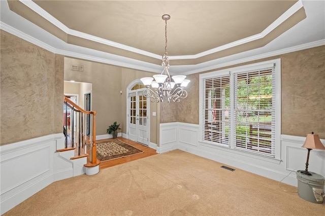 4842 Registry Dr NW, Kennesaw, GA 30152 - unfurnished dining area with a raised ceiling, a chandelier, a wainscoted wall, crown molding, and carpet floors