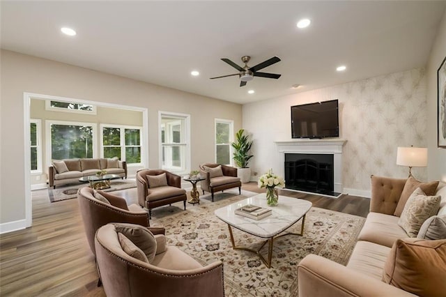 620 Reeves Hill Pt, Lawrenceville, GA 30043 - living area with wood finished floors, baseboards, recessed lighting, ceiling fan, and a fireplace with raised hearth