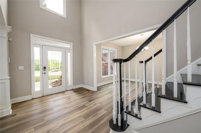 620 Reeves Hill Pt, Lawrenceville, GA 30043 - entryway featuring stairway, wood finished floors, a towering ceiling, and baseboards
