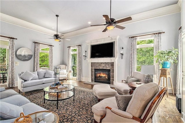 8901 Watkins Mill Rd, Winston, GA 30187 - living area featuring a ceiling fan, light wood-style floors, a fireplace, ornamental molding, and baseboards