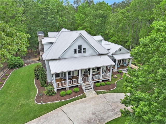 8901 Watkins Mill Rd, Winston, GA 30187 - view of front of property featuring a porch, a chimney, a front yard, a view of trees, and metal roof