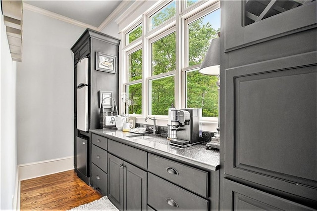8901 Watkins Mill Rd, Winston, GA 30187 - bar featuring a sink, ornamental molding, plenty of natural light, baseboards, and wood finished floors