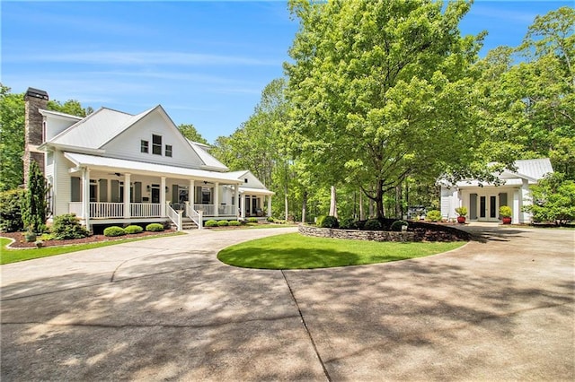 8901 Watkins Mill Rd, Winston, GA 30187 - modern farmhouse featuring french doors, a porch, curved driveway, a chimney, and a front lawn
