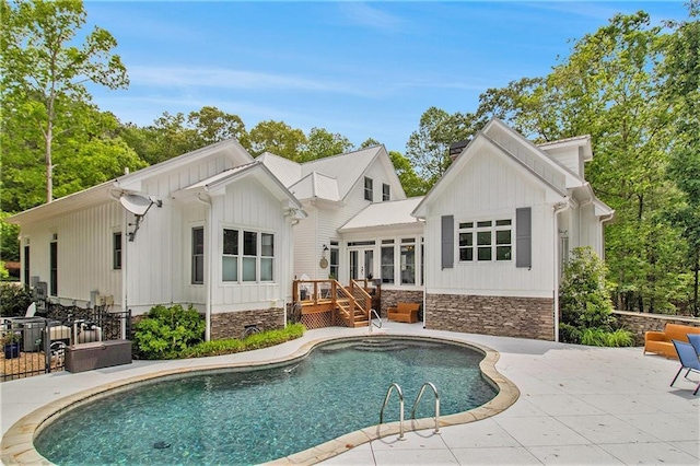8901 Watkins Mill Rd, Winston, GA 30187 - back of house featuring stone siding, an outdoor pool, a patio area, and a wooden deck