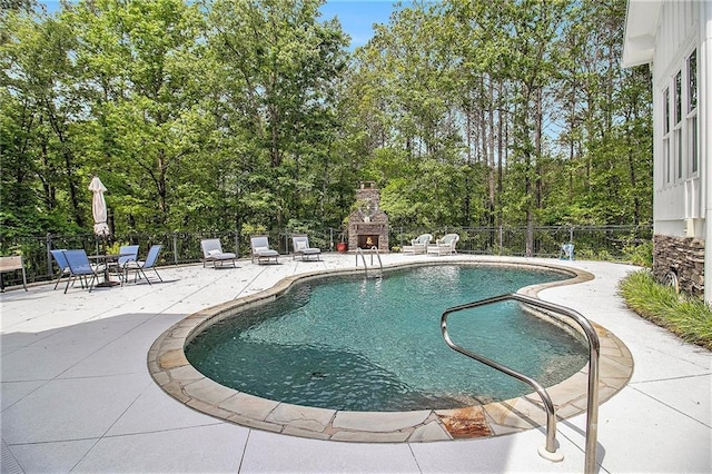 8901 Watkins Mill Rd, Winston, GA 30187 - view of pool with an outdoor stone fireplace, a patio area, and view of wooded area