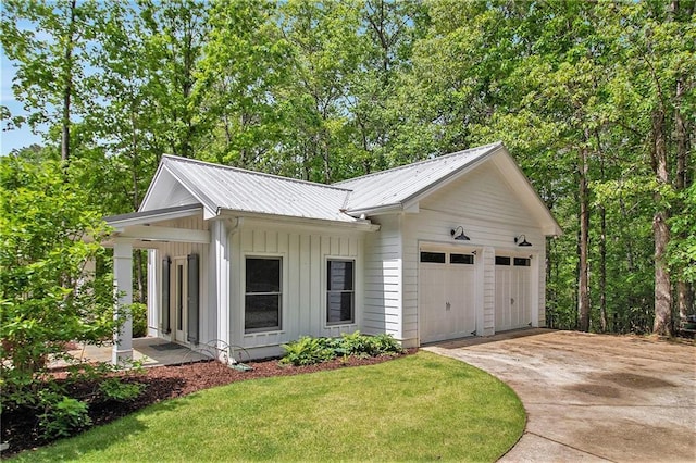 8901 Watkins Mill Rd, Winston, GA 30187 - view of front of property with board and batten siding, a garage, concrete driveway, metal roof, and a front lawn