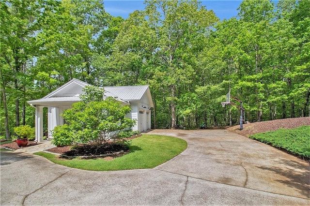 8901 Watkins Mill Rd, Winston, GA 30187 - view of home's exterior featuring driveway, a garage, and metal roof