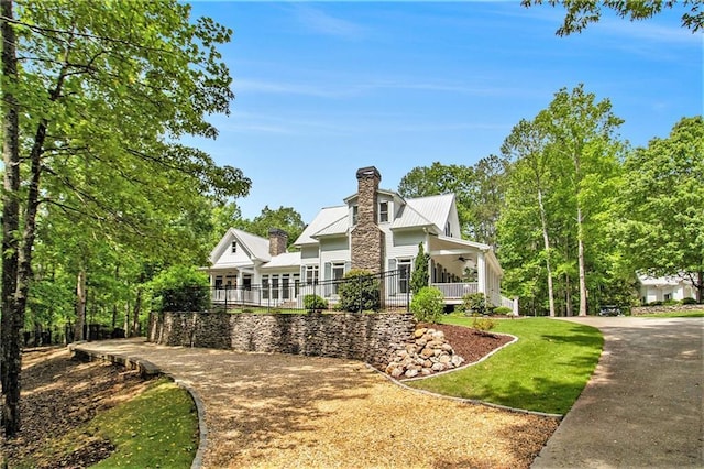 8901 Watkins Mill Rd, Winston, GA 30187 - view of front of house with a ceiling fan, a chimney, metal roof, and a front lawn