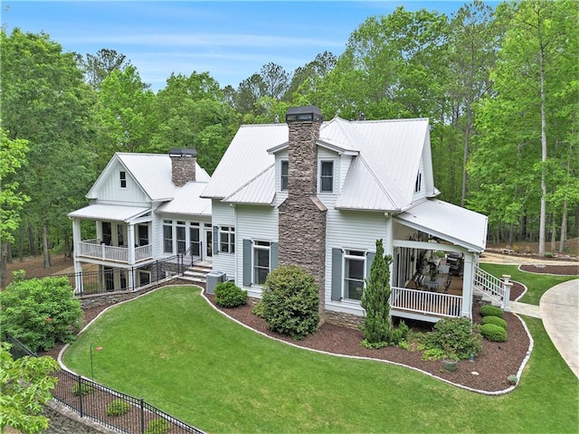 8901 Watkins Mill Rd, Winston, GA 30187 - rear view of property with a chimney, a yard, central AC, and metal roof
