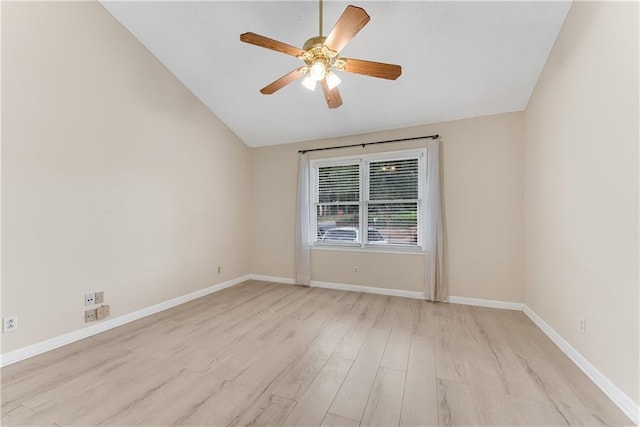 empty room with light wood-type flooring, a ceiling fan, vaulted ceiling, and baseboards