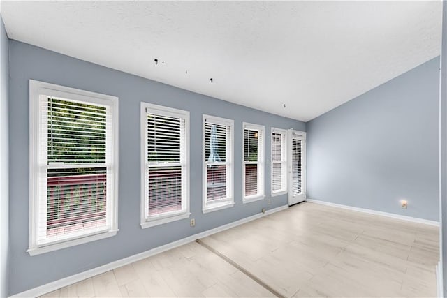 spare room featuring baseboards