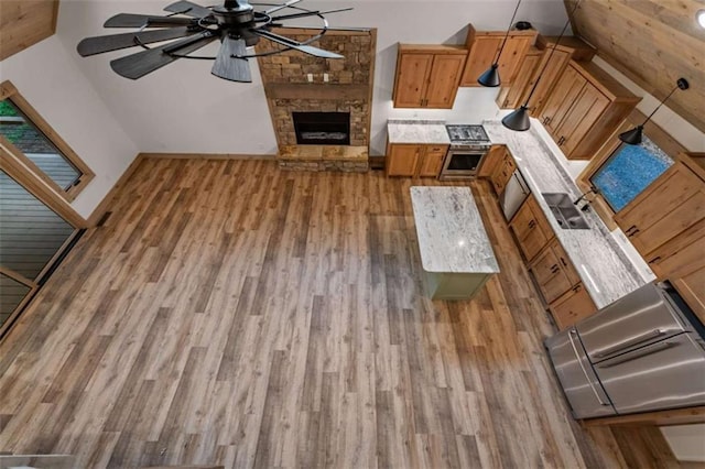 74 Cohutta Overlook Way, Blue Ridge, GA 30513 - unfurnished living room featuring wood finished floors, ceiling fan, a fireplace, and baseboards