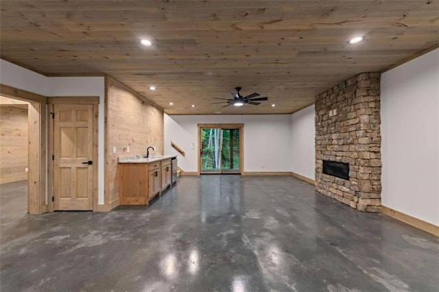 74 Cohutta Overlook Way, Blue Ridge, GA 30513 - unfurnished living room featuring concrete flooring, a stone fireplace, wood ceiling, recessed lighting, and baseboards