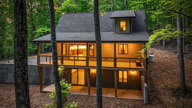 74 Cohutta Overlook Way, Blue Ridge, GA 30513 - back of house with a shingled roof, a balcony, a patio area, and a forest view