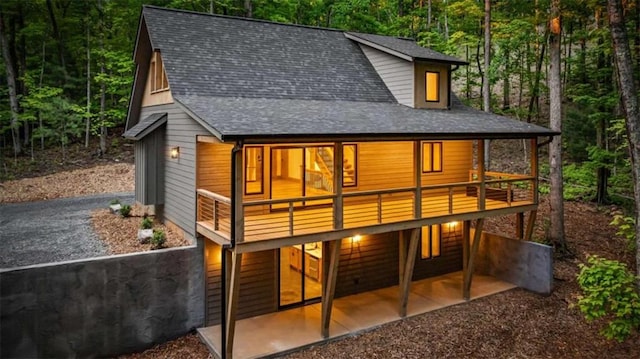 74 Cohutta Overlook Way, Blue Ridge, GA 30513 - rear view of house featuring a view of trees, a shingled roof, and asphalt driveway